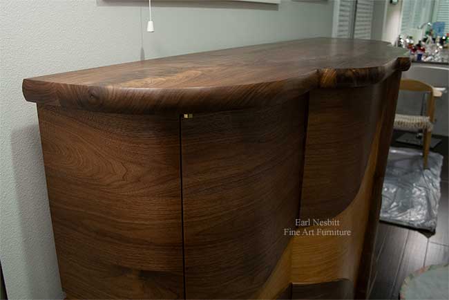 art deco bar cabinet from slightly above emphasizing curved design
